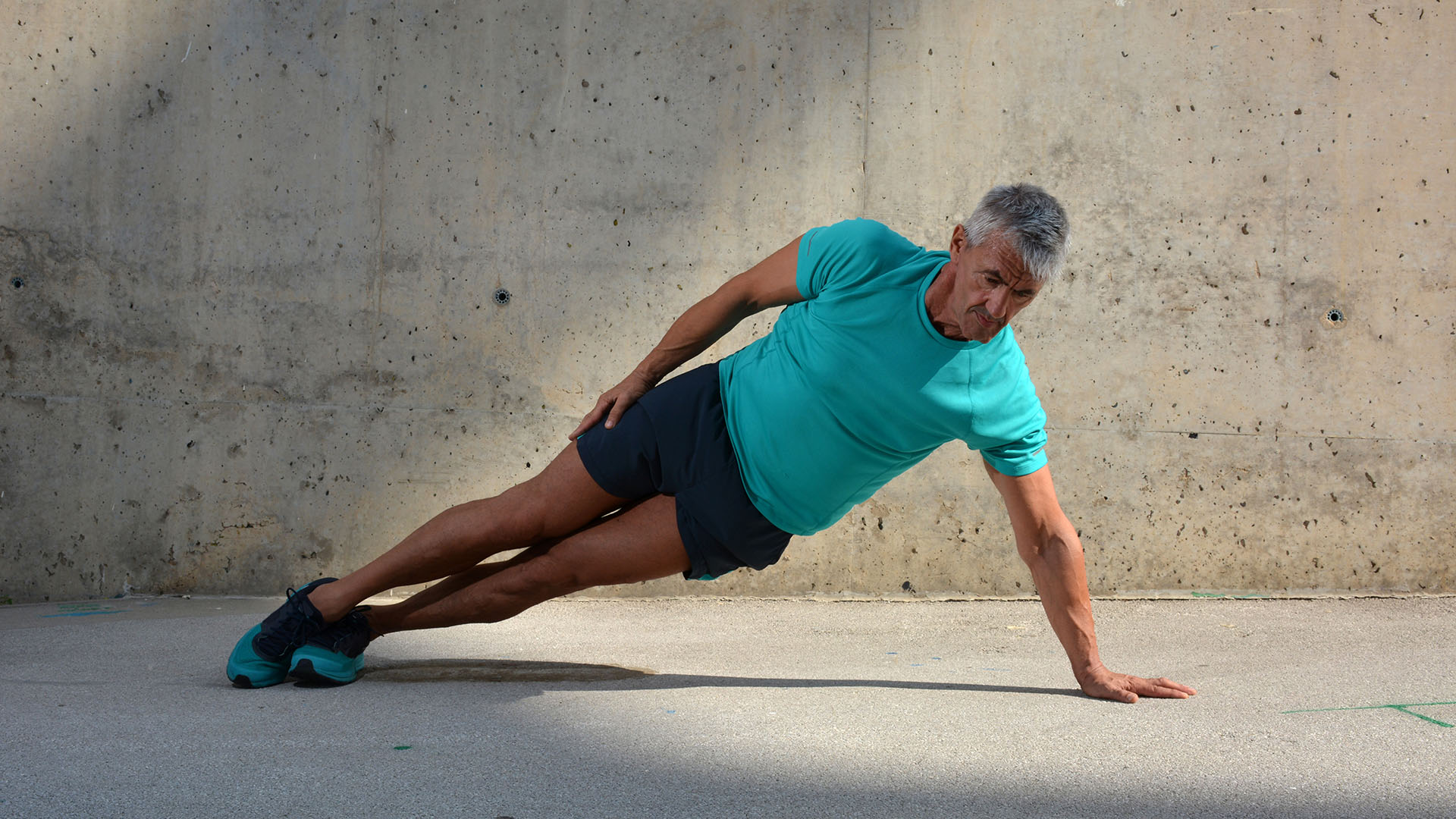 Elderly man practicing sports on the street