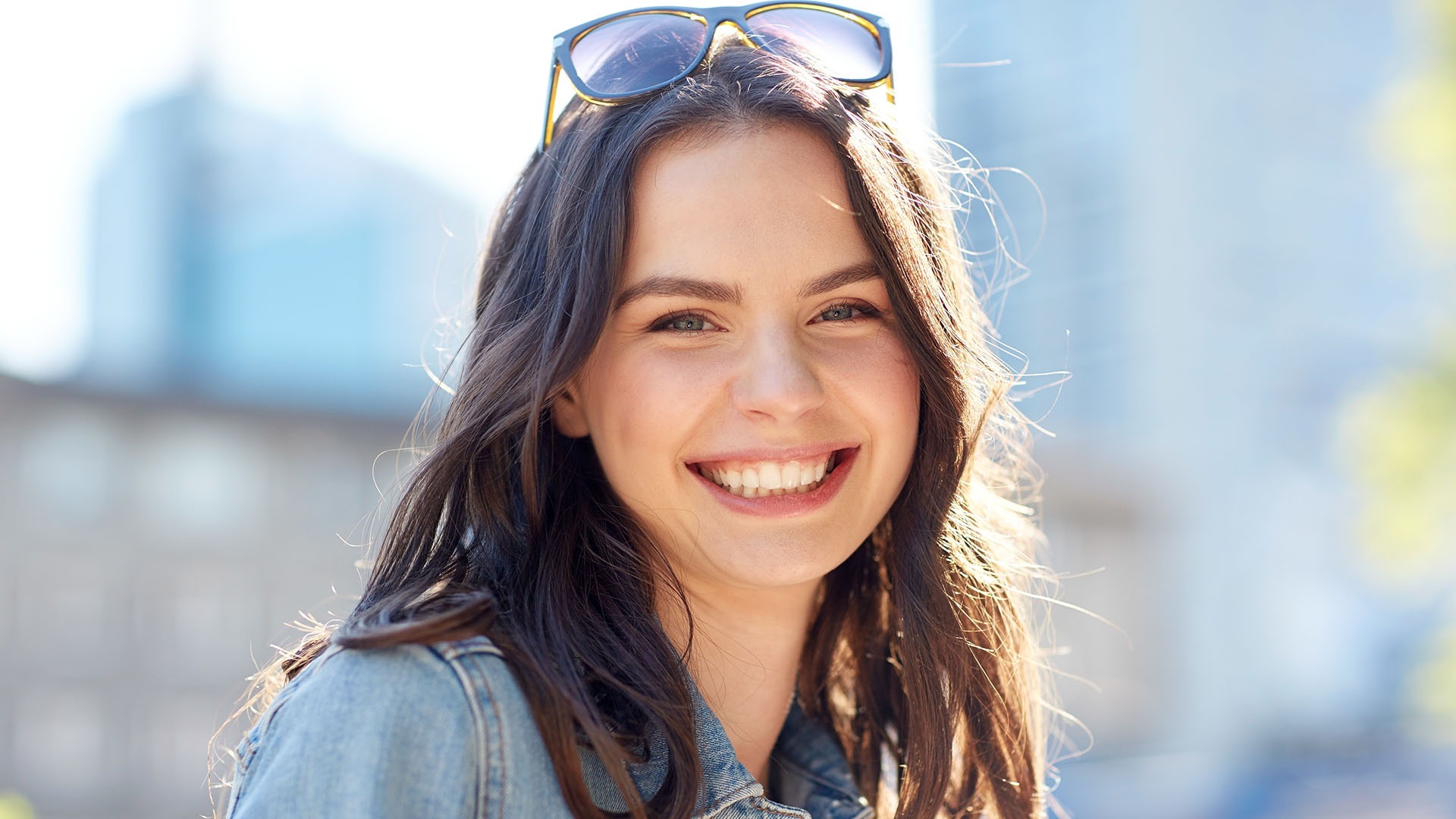 women and people concept - happy smiling young woman on summer city street