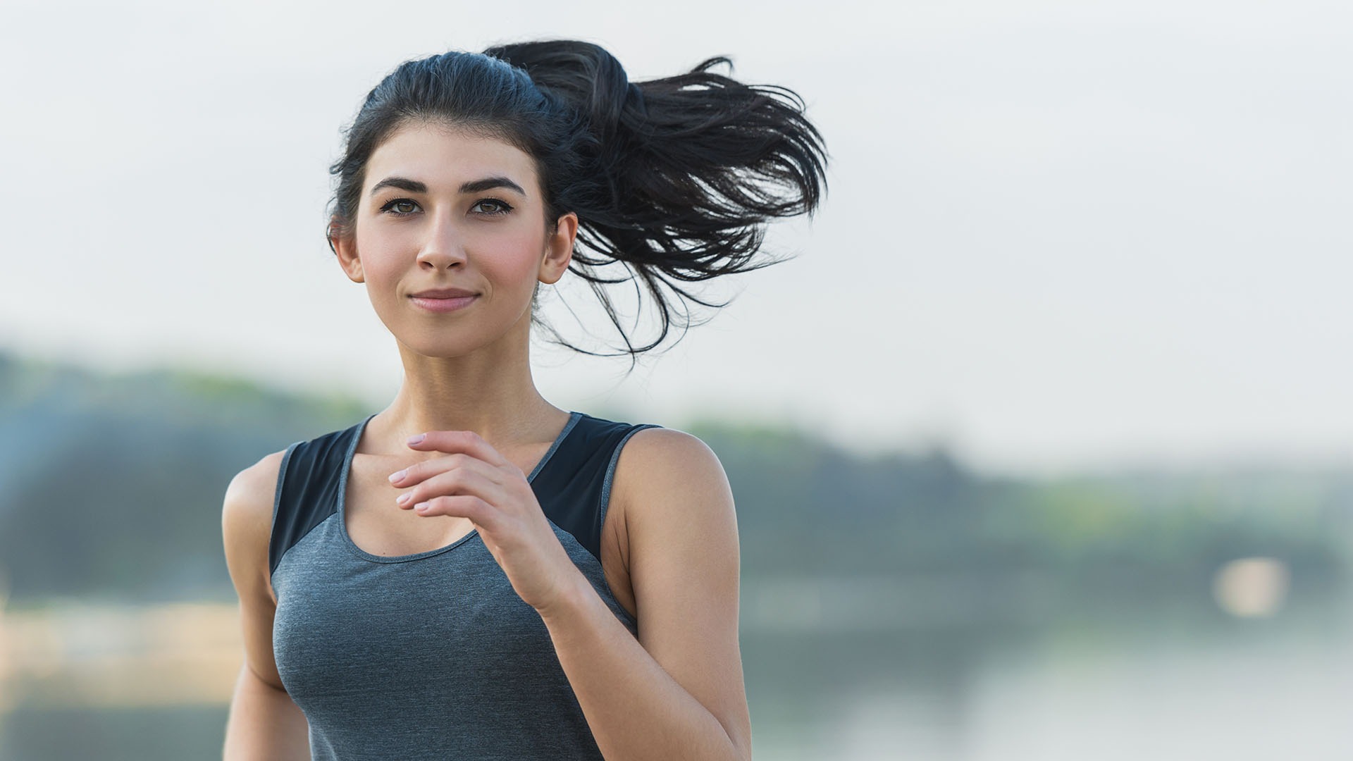 Young lady running on a beach during morning