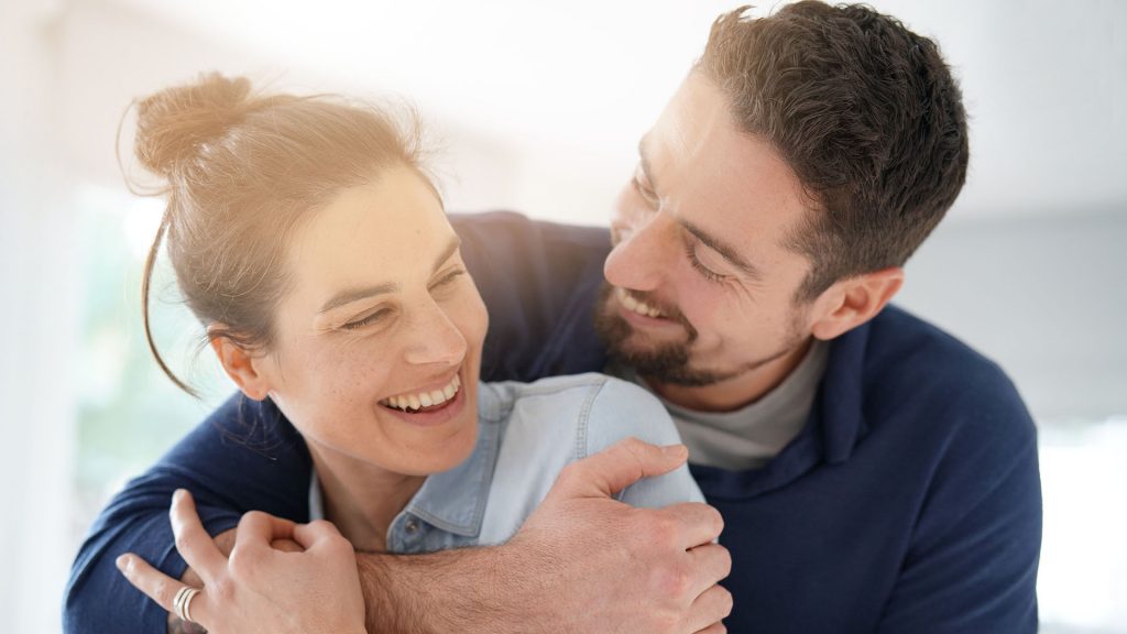 Cheerful romantic couple of lovers cuddling