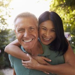 Portrait Of Loving Mature Couple In Back Yard Garden